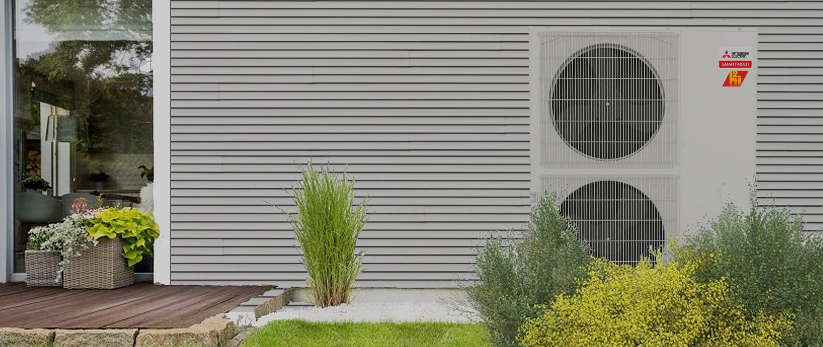 A heat pump outdoor unit against the siding of a house